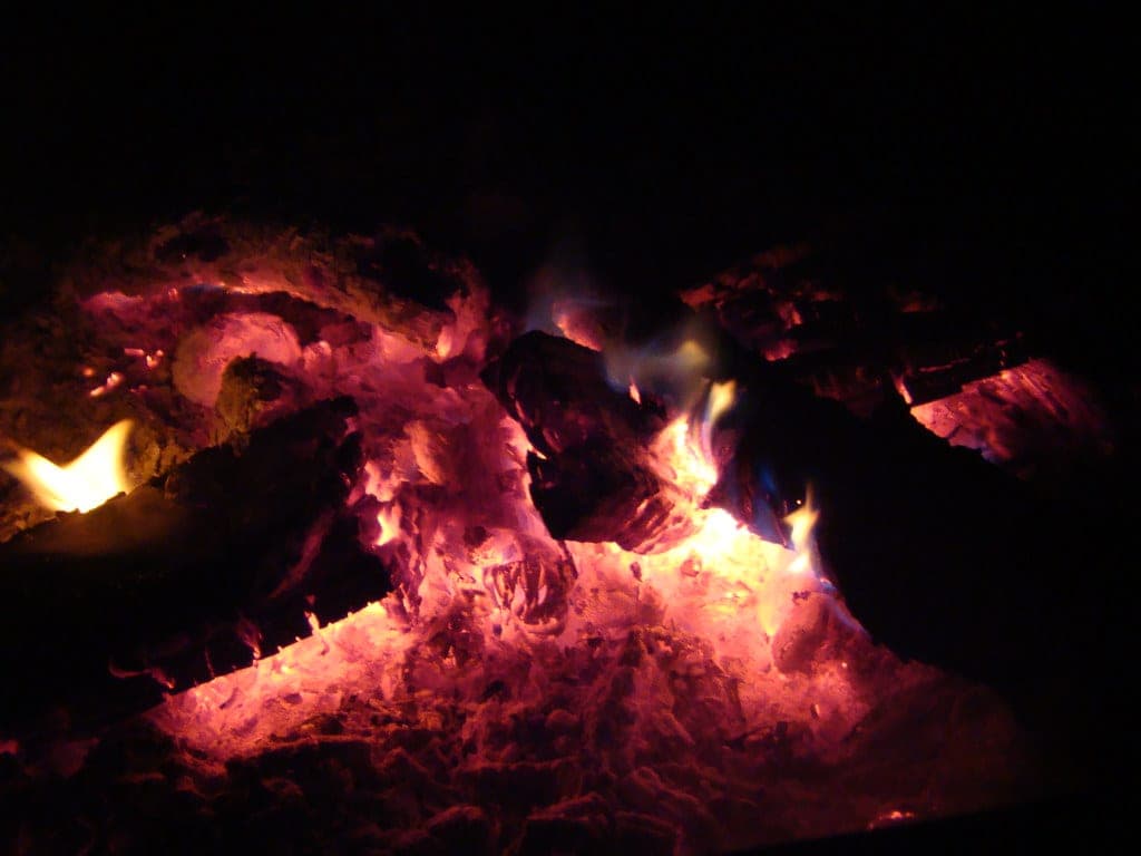Glowing coals in a campfire at night