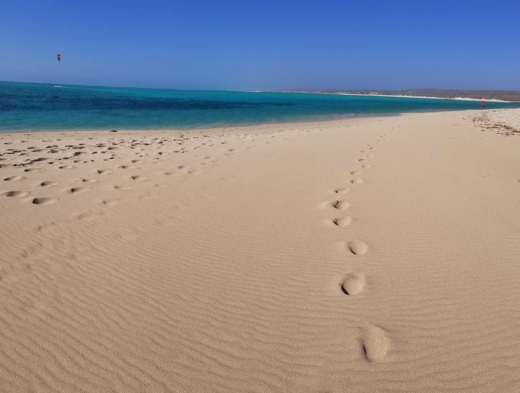 A wide empty beach on the Ningaloo coast with turquoise water