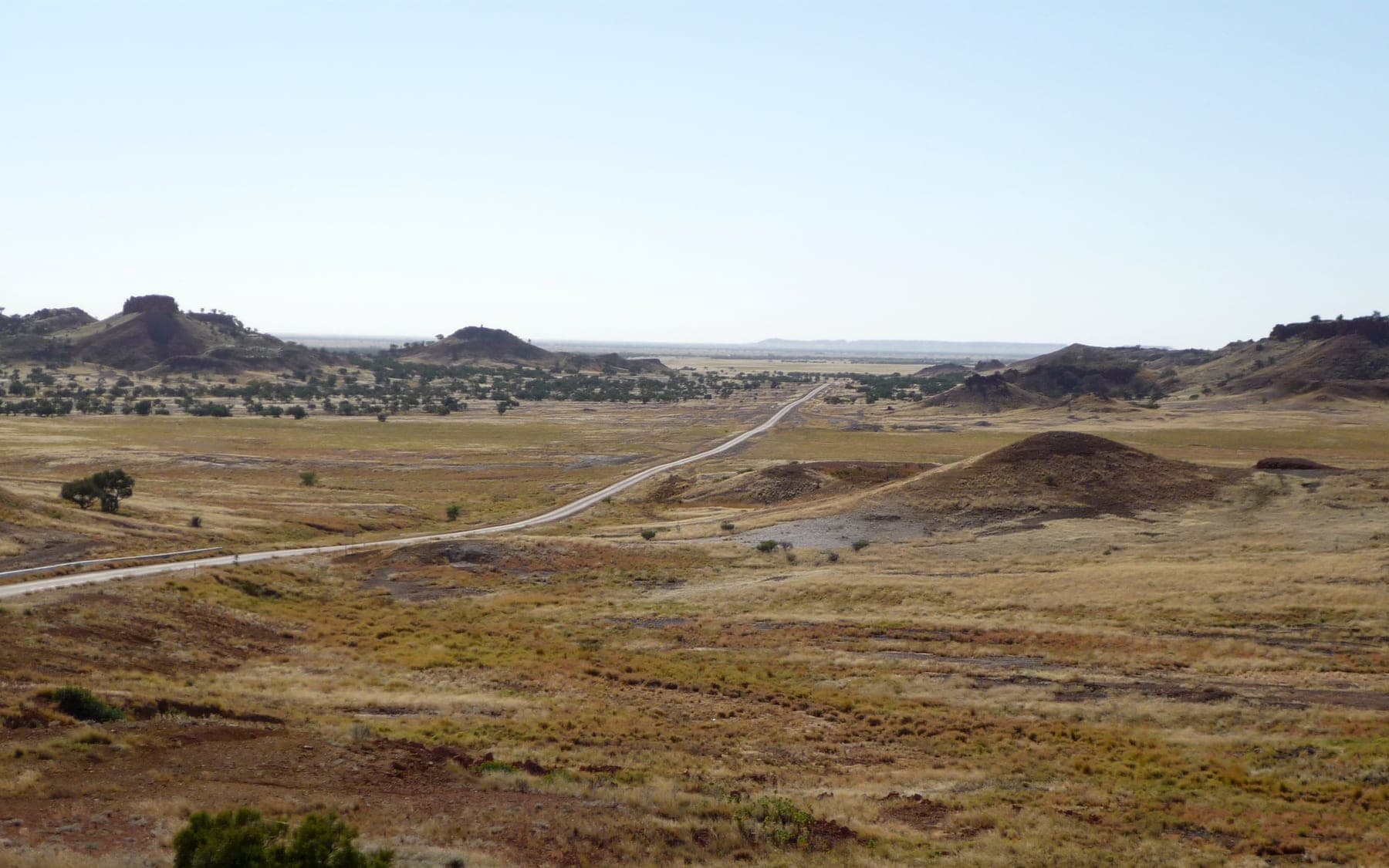 An unsealed outback road running through open country