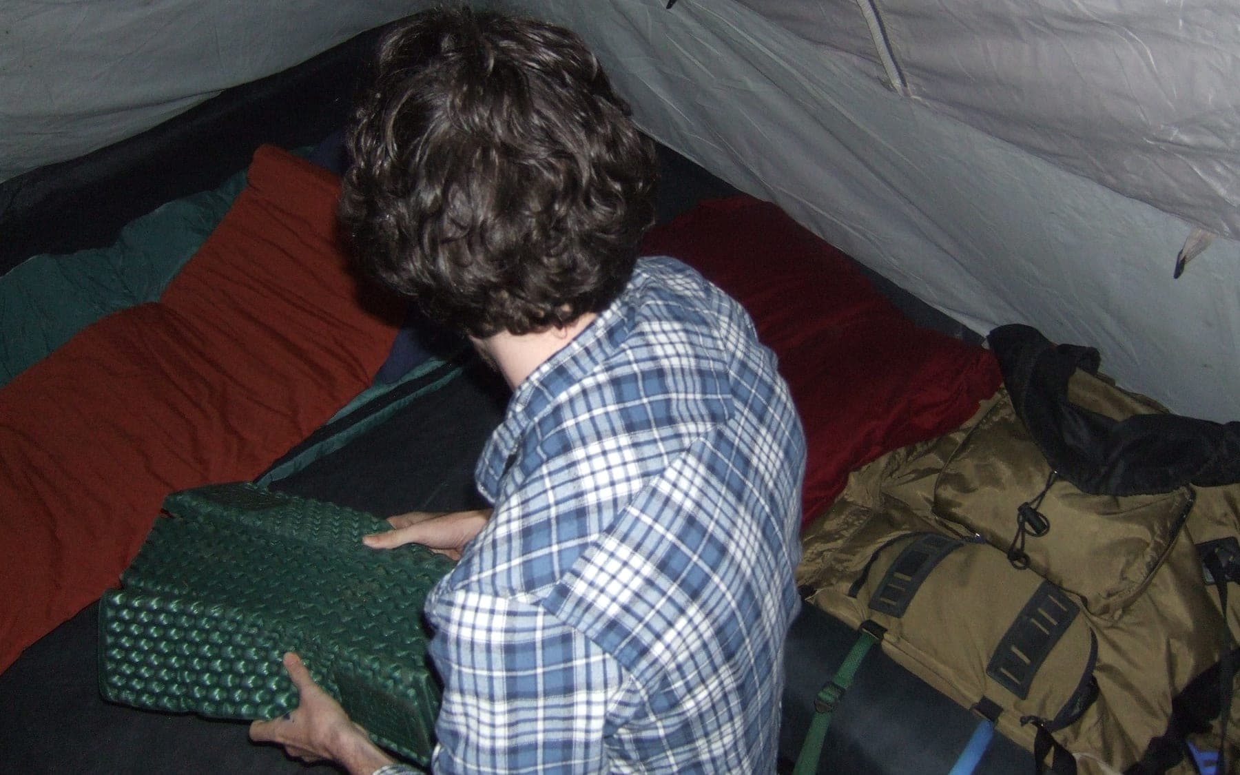 Bedding and gear arranged inside a tent